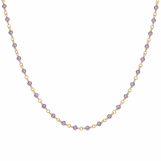 Necklace with purple beads on a gold chain against a white background